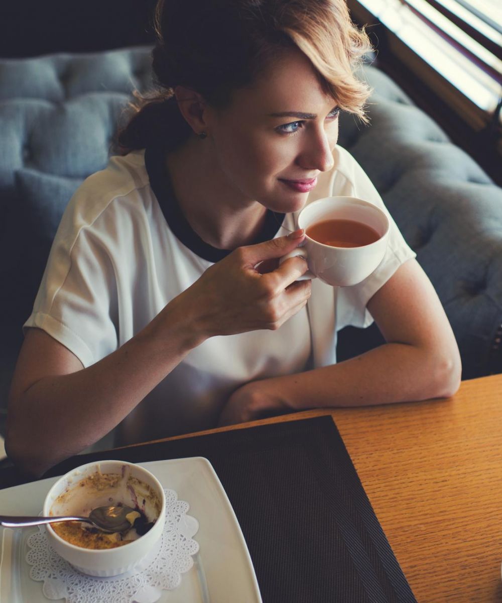 Resident enjoying tea and relaxing lifestyle at The Whitney apartments in Salt Lake City, Utah