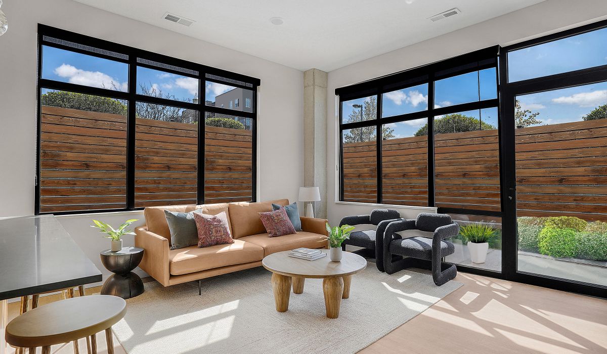 Modern resident lounge with floor-to-ceiling windows at The Whitney apartments in Salt Lake City, Utah